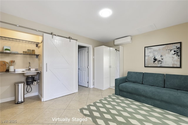 living room featuring light tile patterned flooring, a barn door, and a wall mounted air conditioner