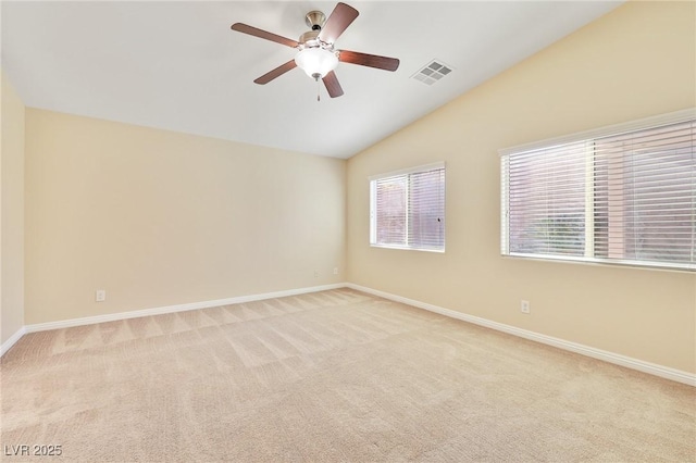 carpeted empty room featuring ceiling fan and vaulted ceiling