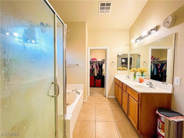 bathroom featuring vanity, plus walk in shower, and tile patterned flooring