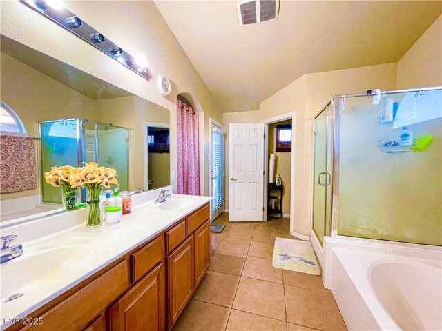 bathroom with tile patterned flooring, shower with separate bathtub, vaulted ceiling, and vanity