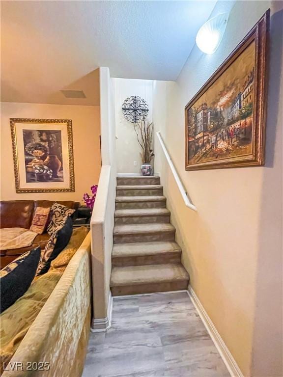 stairway with wood-type flooring