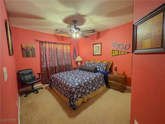 bedroom featuring ceiling fan and carpet