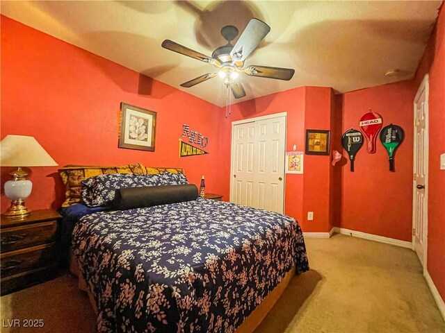 bedroom featuring light carpet, ceiling fan, and a closet