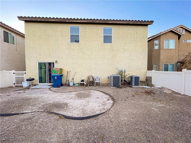 back of house with cooling unit and a patio