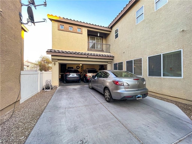 exterior space with a garage and a balcony