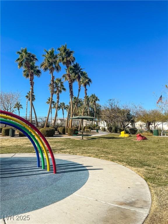 view of home's community with a playground and a yard