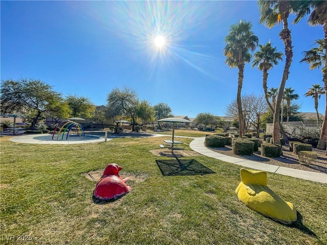 view of home's community with a playground and a lawn