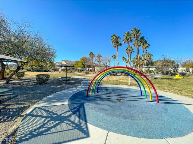 view of property's community with a playground and a lawn