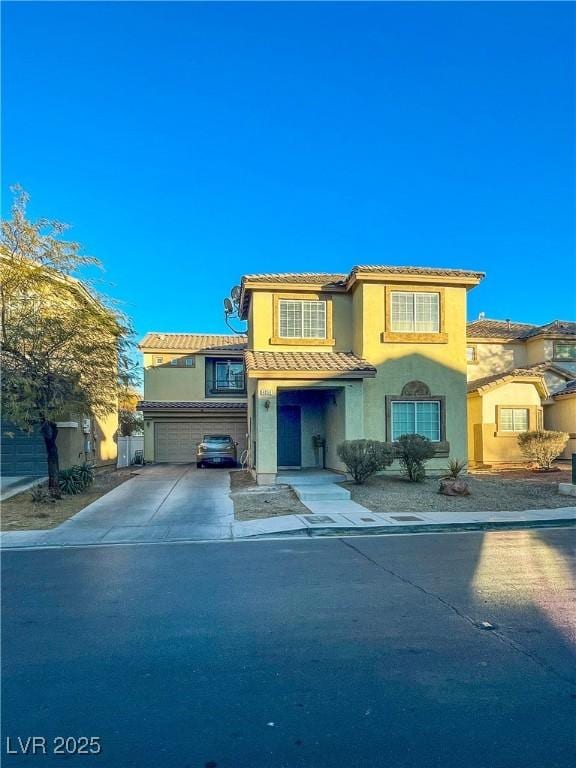 mediterranean / spanish-style house with a garage