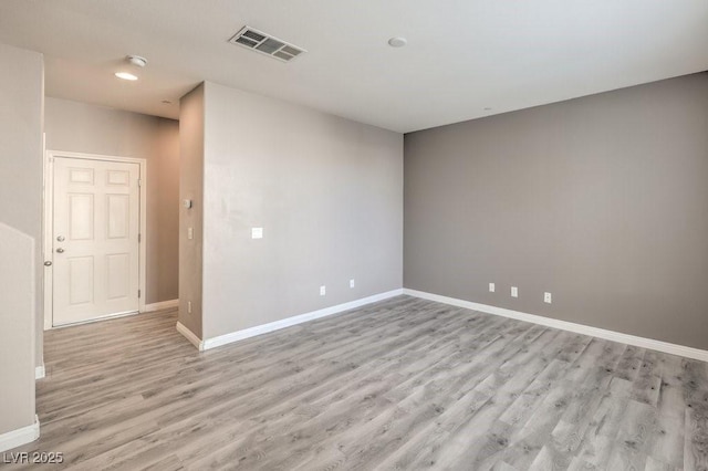 spare room featuring light hardwood / wood-style floors