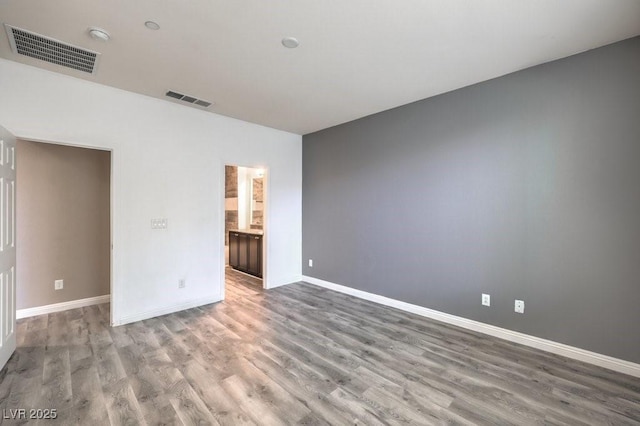 spare room featuring wood-type flooring