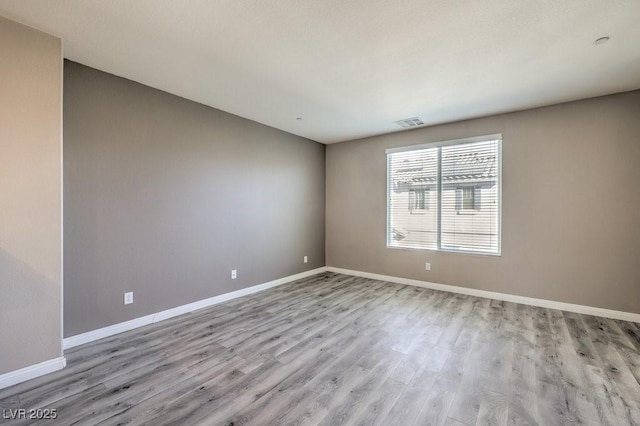 unfurnished room with light wood-type flooring