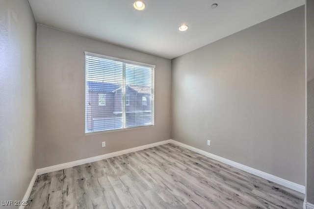 unfurnished room with light wood-type flooring