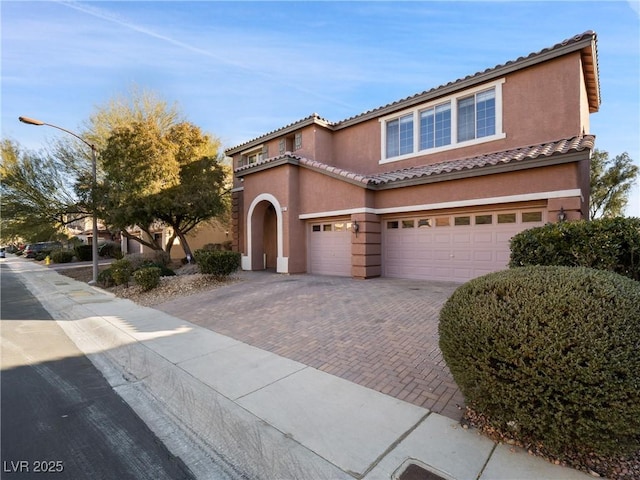 mediterranean / spanish-style home featuring a garage