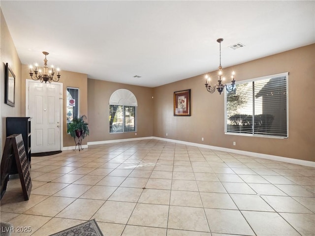 interior space with a notable chandelier and light tile patterned flooring