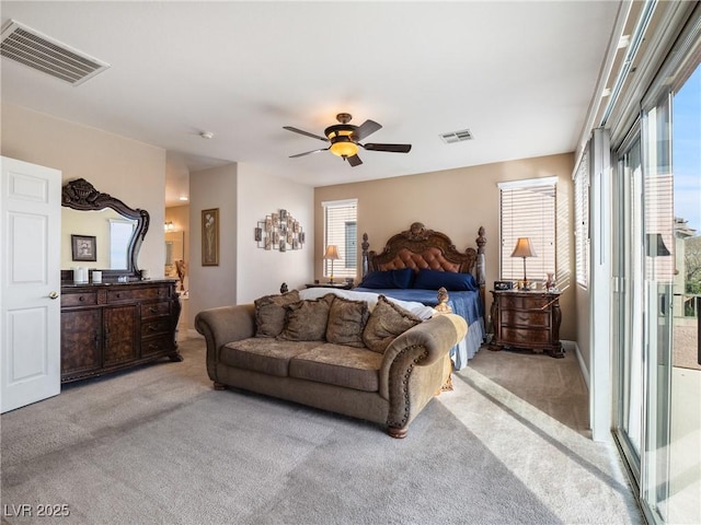 bedroom with light carpet, ceiling fan, and multiple windows