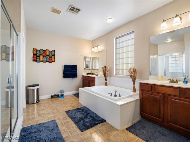 bathroom featuring vanity and shower with separate bathtub