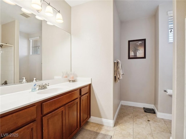 bathroom with vanity, a shower, and tile patterned floors