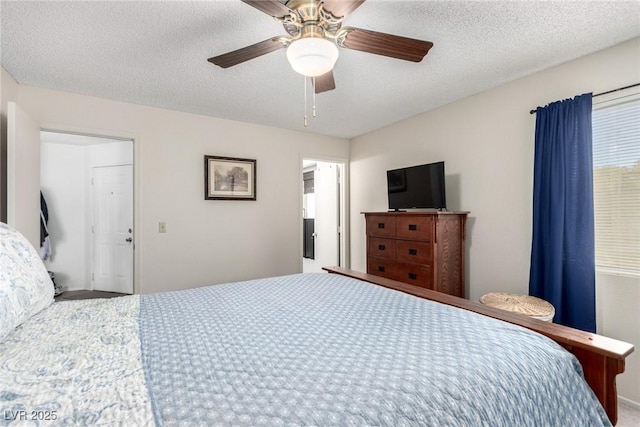 bedroom with a textured ceiling and ceiling fan