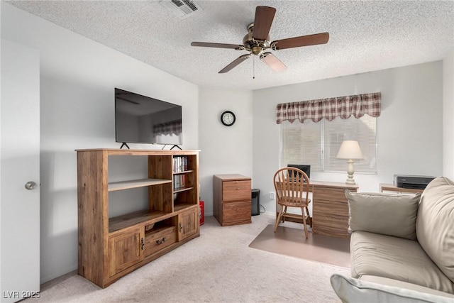 living room featuring light carpet, a textured ceiling, and ceiling fan