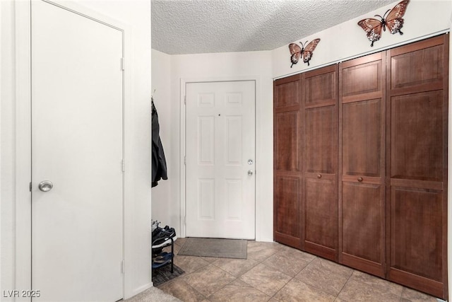 mudroom featuring a textured ceiling