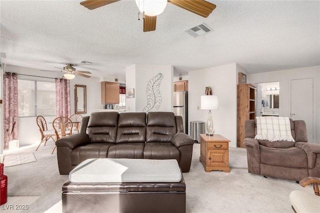 carpeted living room with a textured ceiling