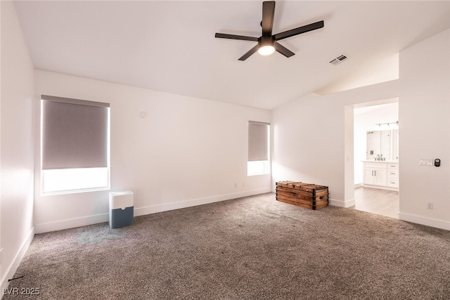 unfurnished room with lofted ceiling, carpet floors, and ceiling fan