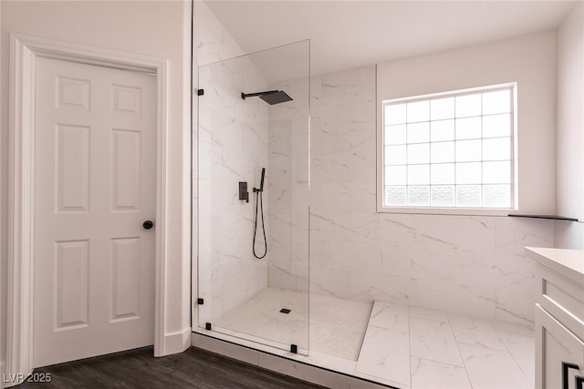 bathroom with a shower with door and vanity