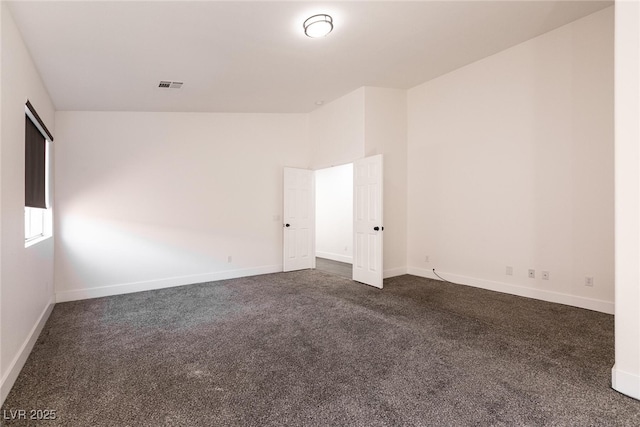 empty room featuring dark colored carpet