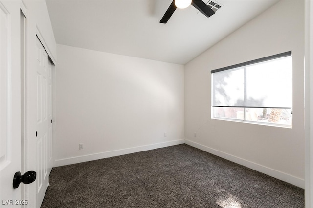 unfurnished bedroom featuring ceiling fan, a closet, lofted ceiling, and dark colored carpet