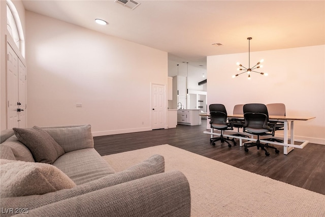 office area featuring a notable chandelier and dark hardwood / wood-style flooring