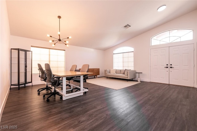 dining area featuring an inviting chandelier, vaulted ceiling, and dark hardwood / wood-style floors