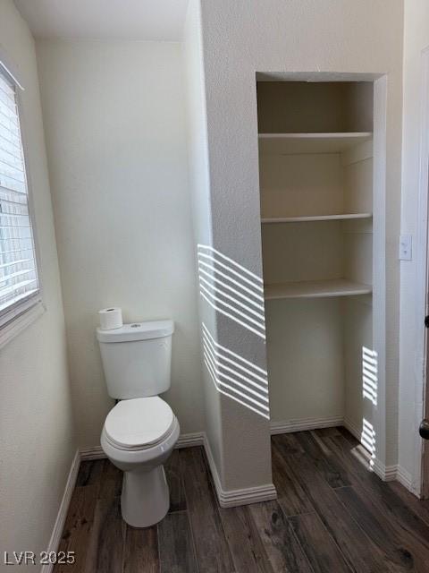 bathroom featuring hardwood / wood-style flooring and toilet