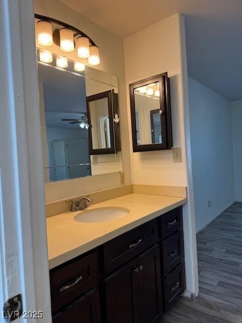 bathroom with hardwood / wood-style floors, vanity, and ceiling fan