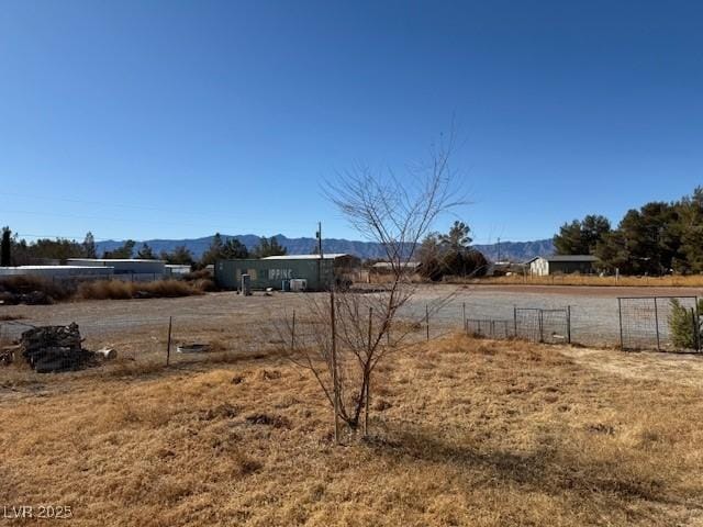 view of yard with a mountain view and a rural view