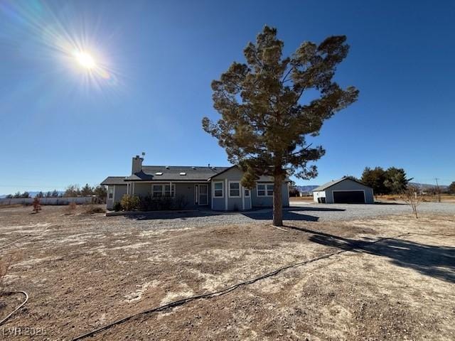 ranch-style home featuring an outbuilding and a garage