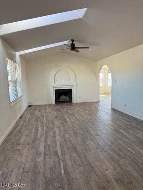 unfurnished living room with ceiling fan, dark hardwood / wood-style flooring, and vaulted ceiling