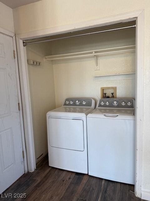 washroom with washer and clothes dryer and dark wood-type flooring