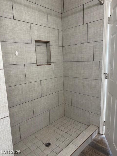 bathroom with a shower and hardwood / wood-style floors