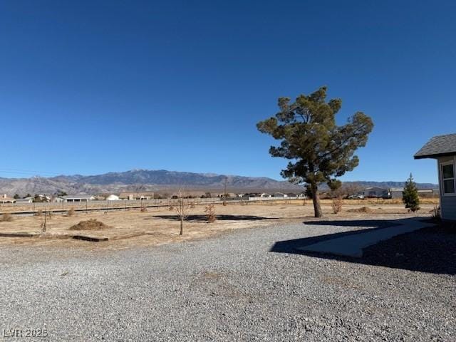 view of yard with a mountain view and a rural view