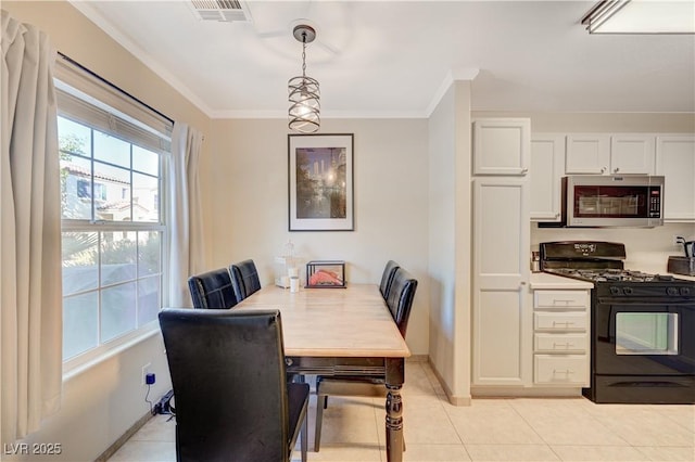 dining room with light tile patterned floors and ornamental molding