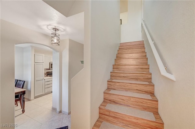 stairway featuring tile patterned flooring