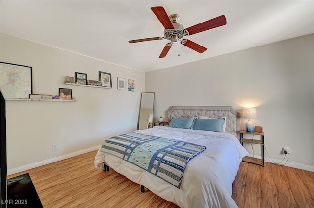 bedroom with ceiling fan and hardwood / wood-style floors