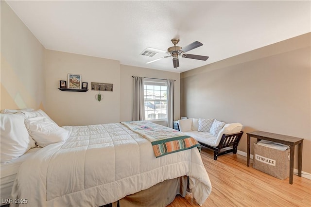 bedroom with ceiling fan and light wood-type flooring