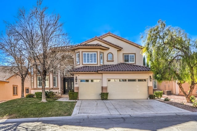 mediterranean / spanish house with central AC, a garage, and a front lawn