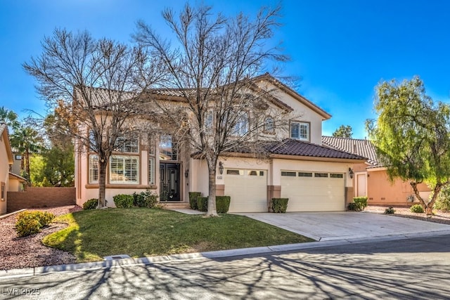 mediterranean / spanish-style house with a garage and a front yard