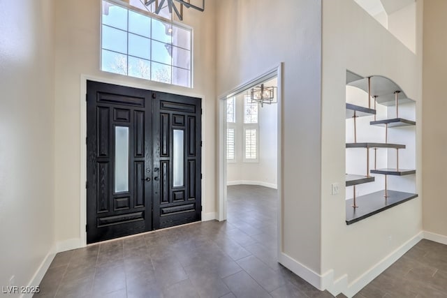 entrance foyer with a towering ceiling and an inviting chandelier