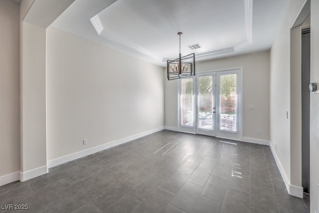 unfurnished dining area with french doors, dark tile patterned flooring, an inviting chandelier, a raised ceiling, and ornamental molding