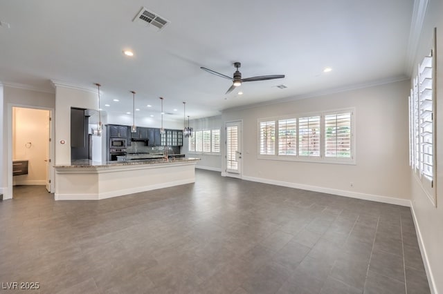 kitchen featuring kitchen peninsula, appliances with stainless steel finishes, light stone counters, ceiling fan, and decorative light fixtures