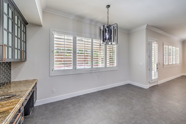 unfurnished dining area with a chandelier and crown molding